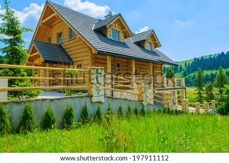 Traditional wooden mountain house on green field in summer, Szczawnica, Beskid Mountains, Poland