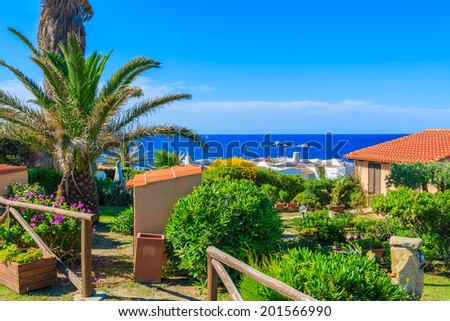 Tropical garden and holiday house on coast of Sardinia island near Cala Caterina beach, Italy
