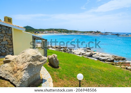 Holiday house on coast of Sardinia island - view from promenade at Spiaggia del Riso beach, Italy