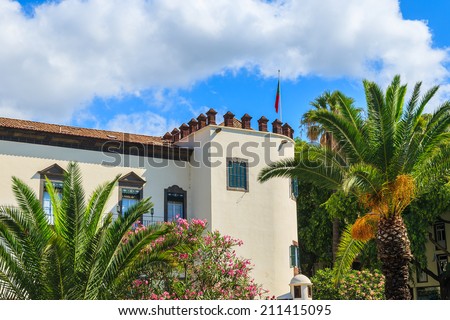Palm trees and colonial architecture of palace in Funchal historic old town center on Madeira island, Portugal