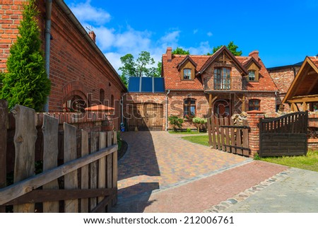 LEBA, POLAND - JUNE 10, 2013: traditional house built from red bricks in coastal town of Leba. This town is very popular holiday destination for tourists in summer.