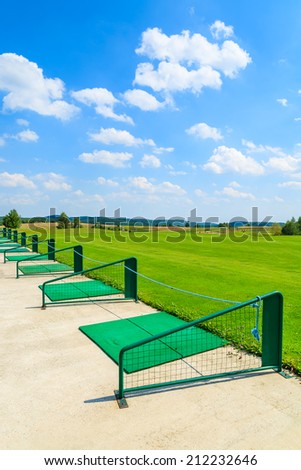 PACZULTOWICE GOLF CLUB, POLAND - AUG 9, 2014: Long range shooting station at beautiful golf play area on sunny summer day. Golfing becomes popular sport among wealthy Poles.