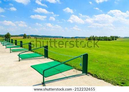 PACZULTOWICE GOLF CLUB, POLAND - AUG 9, 2014: Long range shooting station at beautiful golf play area on sunny summer day. Golfing becomes popular sport among wealthy Poles.