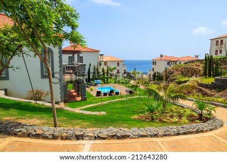 MADEIRA, PORTUGAL - AUG 27, 2013: alley in gardens of luxury hotel on coast of Atlantic Ocean. Madeira island is famous for best hotels in Portugal and for climate of eternal spring.