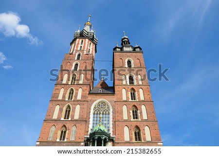 St. Mary\'s Gothic Church (Mariacki Church) in Krakow against blue sunny sky, Poland