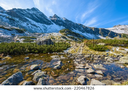Water stream on hiking trail in Gasienicowa valley in autumn season, High Tatra Mountains, Poland