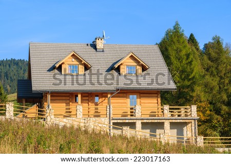 Wooden mountain house built from wood logs on sunny day, Pieniny Mountains, Poland