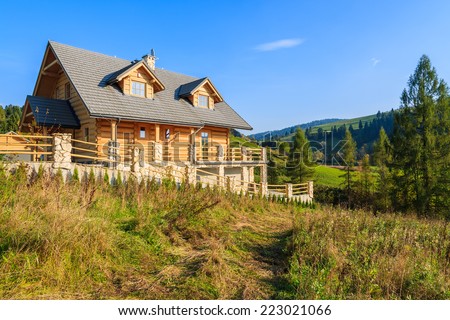 Wooden mountain house built from wood logs on sunny day, Pieniny Mountains, Poland
