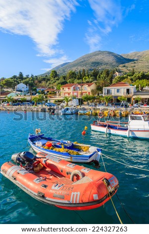AGIA EFIMIA PORT, KEFALONIA ISLAND, GREECE - SEP 18, 2014: red pontoon boat mooring in port of Agia Efimia. This coastal village is very popular among tourists sailing between Greek islands.