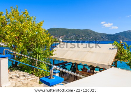 FISKARDO, KEFALONIA - SEP 18, 2014: Traditional Greek tavern in Fiskardo port, Kefalonia island, Greece. Greece is famous for great food and sunny weather.