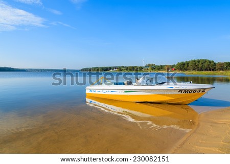 CHANCZA LAKE, POLAND - OCT 4, 2014: motor boat on shore of beautiful Chancza lake. Water sports are becoming more and more popular among Polish people.