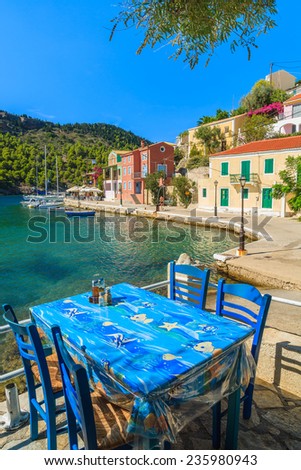 Table in Greek tavern on coast of Kefalonia island in Assos fishing village, Greece
