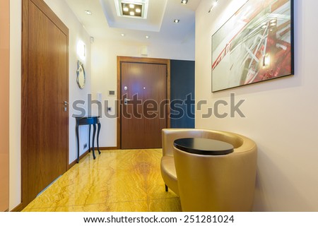 Interior corridor with marble floor and armchair at a modern luxury apartment, Krakow city, Poland