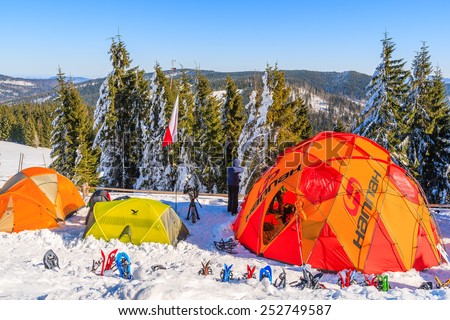 GORCE MOUNTAINS, POLAND - FEB 14, 2015: colorful tents of winter camp located near Turbacz shelter. Every February tourists learn climbing and survival techniques in winter time.
