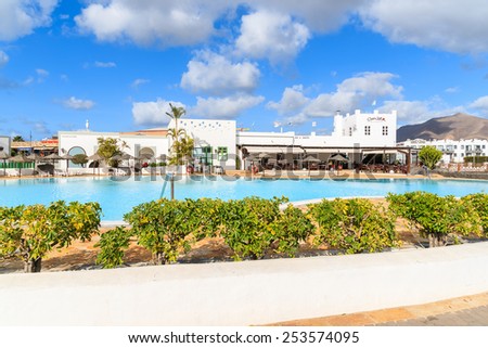 PLAYA BLANCA, LANZAROTE ISLAND - JAN 17, 2015: swimming pool of luxury apartment complex built in traditional Canary style on Lanzarote island. Canary Islands are popular holiday destination.