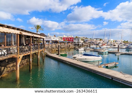 MARINA RUBICON, LANZAROTE ISLAND- JAN 17, 2015: pier and restaurant in Rubicon port. Canary Islands are very popular holiday destination due to sunny tropical climate all year round.