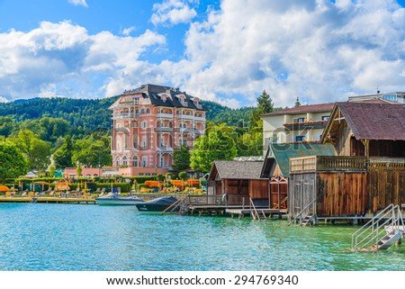 WORTHERSEE LAKE, AUSTRIA - JUN 20, 2015: luxury hotel Astoria on shore of beautiful alpine lake Worthersee in summer. This is most popular lake in Austria among tourists.
