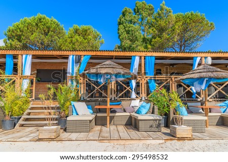 Luxury beach bar with sofas on sandy Palombaggia beach, Corsica island, France
