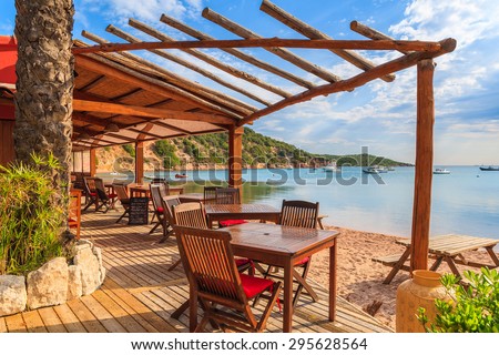 Chairs and tables in beach bar in Santa Manza bay, Corsica island, France