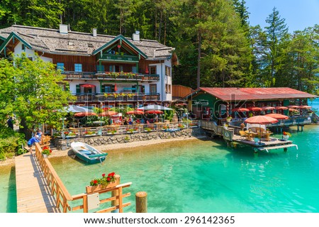 WEISSENSEE LAKE, AUSTRIA - JUL 7, 2015: restaurant and guest house on shore of Weissensee lake in summer time. Weissensee has drink quality of water and is highest situated bathing lake in Carinthia.