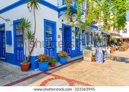 SAMOS ISLAND, GREECE - SEP 21, 2015: blue and white color traditional Greek tavern in Kokkari town on coast of Samos island, Greece.