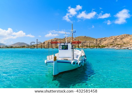 Traditional fishing boat on azure crystal clear sea water in Kolymbithres bay, Paros island, Greece
