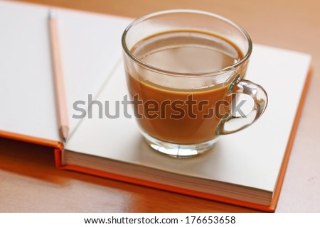 Hot coffee put on the orange book