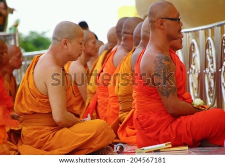 Ang Thong, Thailand-July 11,2014: Buddhists and monks meditation round the temple, in Asaha Puja Day and the beginning of Buddhist Lent, at Wat Muang- Ang Thong, Thailand.