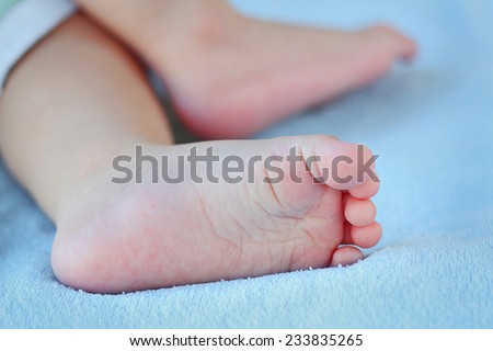 baby feet on blue cloth