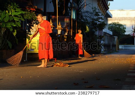Lamphun, Thailand - November 11:Unidentified Buddhist monk was street sweeping in the morning at Wat Phra That Hariphunchai, Thailand temple in Lamphun, Thailand on November 11, 2014