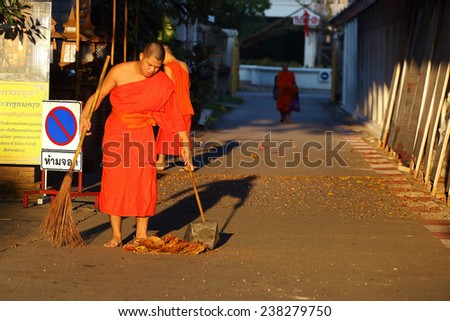 Lamphun, Thailand - November 11:Unidentified Buddhist monk was street sweeping in the morning at Wat Phra That Hariphunchai, Thailand temple in Lamphun, Thailand on November 11, 2014