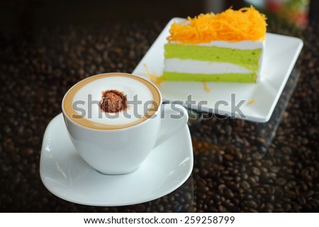 Mocha in white coffee cup and Foythong Cake or Gold Egg Yolks Thread Cake in the Coffee Shop