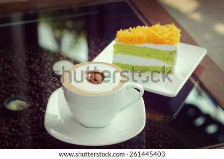 Mocha in white coffee cup and Foythong Cake or Gold Egg Yolks Thread Cake in the Coffee Shop, retro and vintage tone