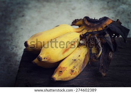 Still life, cultivated bananas on the old wooden table, Fruit in Thailand.
