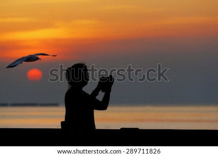 Asian woman standing at the sea, silhouette