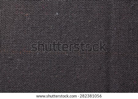 Abstract dark color background from synthetic fabric.