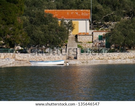 The settlement on the island Lavsa in the Kornati archipelago in Croatia with a sheep on the path