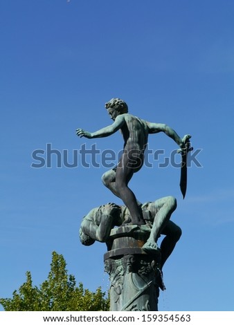 A fountain with a sculpture David and Goliath of bronze in the coastal city Kalmar in Sweden