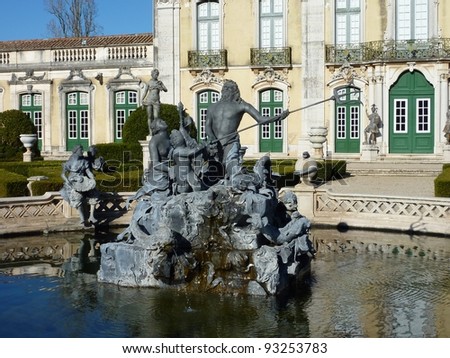 A bronze statue of Neptune in one of the fountains in the garden of the Queluz palace in Portugal