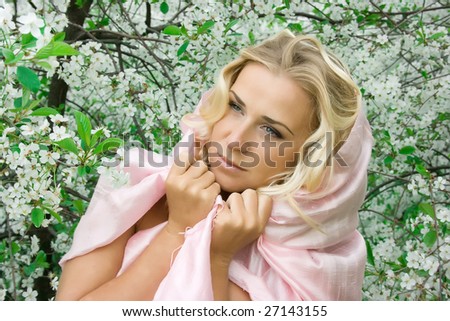 Blonde lady with shawl in spring cherry garden