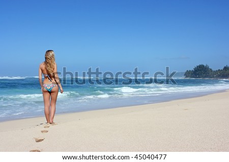 stock photo : Young woman standing alone on the beach