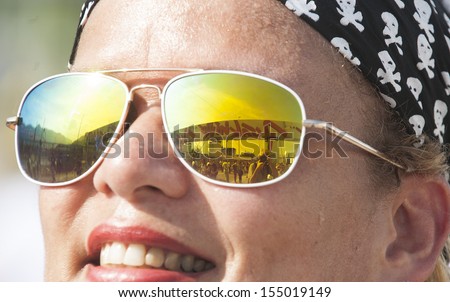 RIO DE JANEIRO, BRAZIL - SEPTEMBER 20: The Rock in Rio 2013 sign reflected on a Rock and Roll fan sunglasses standing by the main entrance of the festival, on September 20, 2013 in Rio de Janeiro, Brazil.