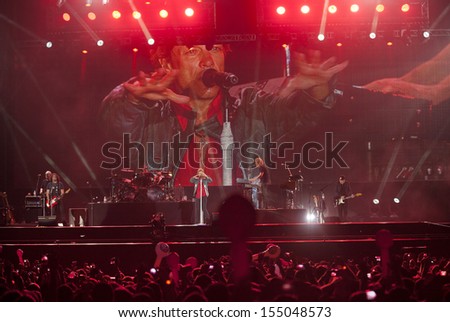 RIO DE JANEIRO, BRAZIL - SEPTEMBER 20: Fans sing along with Jon Bon Jovi, lead singer of the US rock band Bon Jovi, during their performance at the Rock in Rio 2013 concert, on September 20, 2013 in Rio de Janeiro, Brazil.