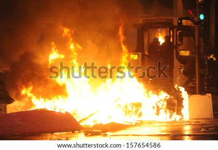 RIO DE JANEIRO, BRAZIL - OCTOBER 08: A bus on fire during schoolteachers demonstrations demanding better wages on October 8th, 2013 in Rio de Janeiro, Brazil.