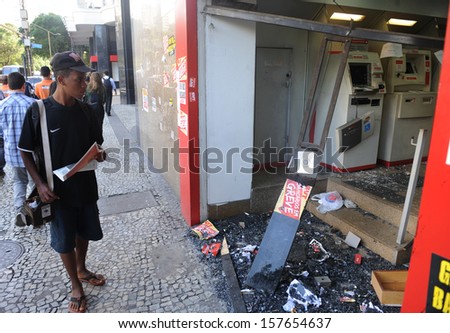 RIO DE JANEIRO, BRAZIL - OCTOBER 08: A local resident looks at a vandalized bank agency at Rio de Janeiro\'s downtown on the day after the schoolteachers demonstrations demanding better wages on October 8th, 2013 in Rio de Janeiro, Brazil.