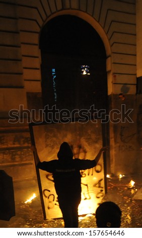 RIO DE JANEIRO, BRAZIL - OCTOBER 08: Black Bloc protesters throw molotov cocktails against the Chamber of Counselors municipal building during schoolteachers demonstrations demanding better wages on October 8th, 2013 in Rio de Janeiro, Brazil.