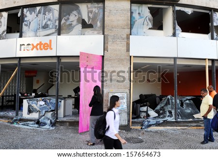RIO DE JANEIRO, BRAZIL - OCTOBER 08: A local residents look the destroyed Nextel store at Rio de janeiro\'s downtown on the day after schoolteachers demonstrations demanding better wages on October 8th, 2013 in Rio de Janeiro, Brazil.