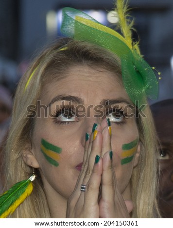 Rio de Janeiro, Brazil - JULY 08, 2014: Soccer fan of Brazil reacts after Brazil defeated by Germany during the World Cup Semi-finals game at the Fan Fest in the Copacabana beach. NO USE IN BRAZIL.