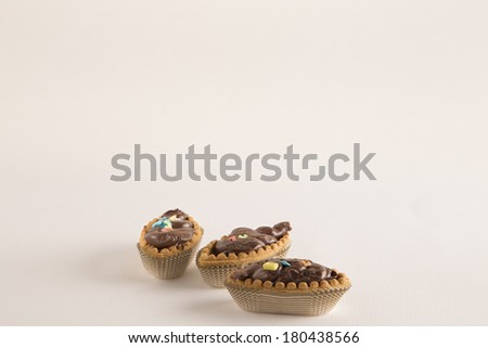 Boat shaped shortcakes filled with  chocolate spread and sugar stars and letters: typical italian confectionery