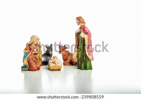 A simple Christmas Crib where the little statues represent the Holy Family, the Virgin Mary, Saint Joseph and the infant Jesus, watched by ox and donkey during the night of the 25th of December
